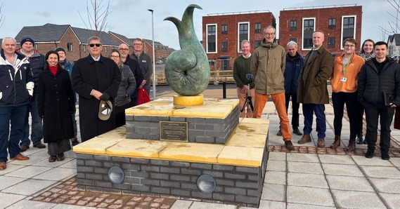 People gather at the unveiling of a new sculpture at the opening of Tithebarn Local Centre