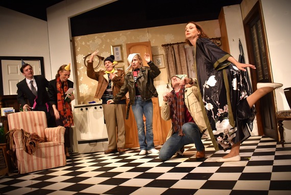 Six actors on a home interior set in funny outfits and poses 