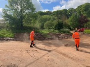 Streetscene workers clearing a road following flooding