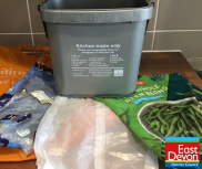 Plastic bags below a food waste caddy