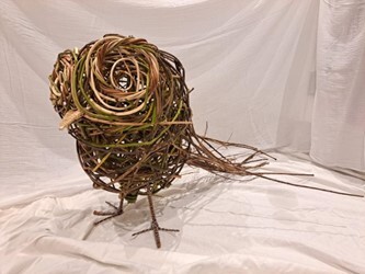 An owl sculpture crafted out of willow
