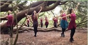 Dancers surround a large tree