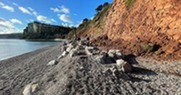 Seaton Hole. sea on the left hand side, with pebbles in the foreground, and cliff to the right, and in the background.jpg