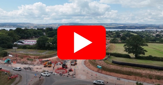 Play button on top of aerial image of Dinan Way improvement work