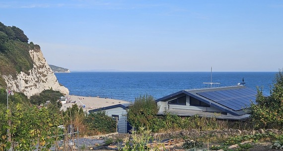 Small building with solar panels overlooking the beach