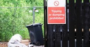 Tipping or dumping prohibited sign on a fence
