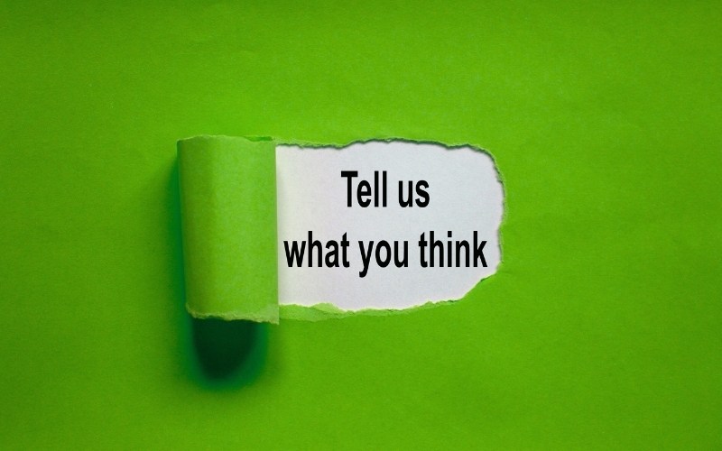 A green envelope with a rip revealing the phrase "tell is what you think"