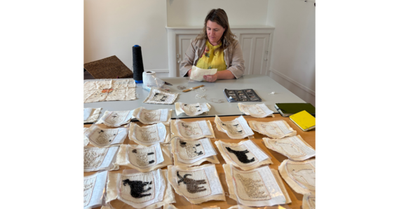 Kat Blockley with her textile piece featuring 30 rare breed sheep