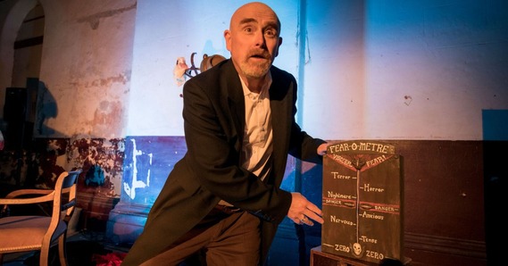 Vic Llewellyn performing No One Is Listening (A Ghost Story) on set. Next to him is a 'fear-o-metre'