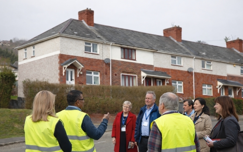 A group of officers and residents on a road in a council estate