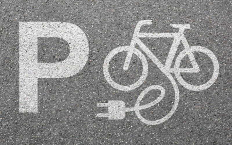 A symbol of an electric bike on tarmac, indicating this is a place you can change your e-bike
