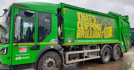 Green recycling vehicle with 'That's Clipping Brilliant' graphic on the side