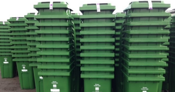 Stacks of green waste bins