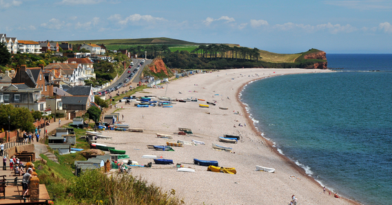 Budleigh beach and sea on the right hand side, buildings on the left
