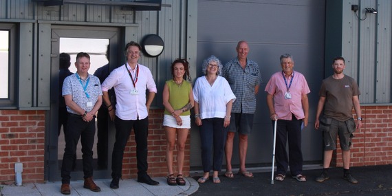 Councillors and business employees in front of commercial units