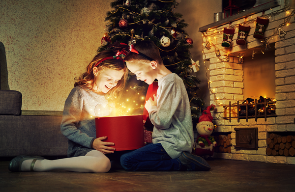 Children open a glowing Christmas present