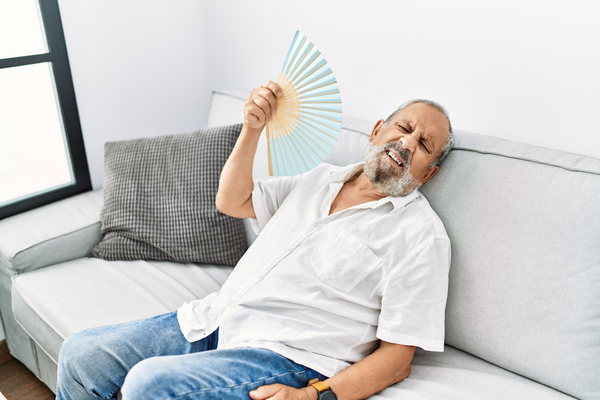 Man fanning himself to keep cool