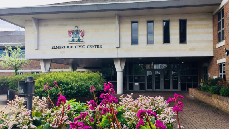 The Elmbridge Civic Centre building with pink flowers outside