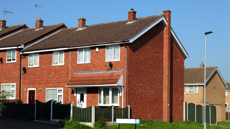 A red-brick semi-detached house.