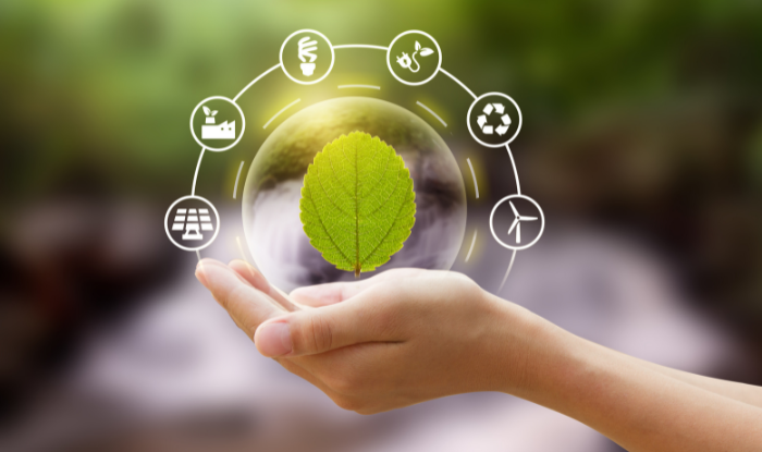 A hand holding a leaf surrounded by small icons that represent sustainability and climate change.