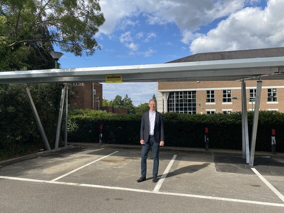 Cllr David Young stood below the new solar car port in the Civic Centre