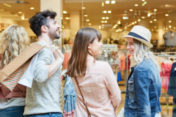 A group of three people shopping together.