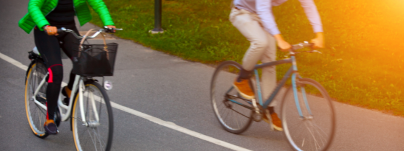 two bicycles riding on a cycle path