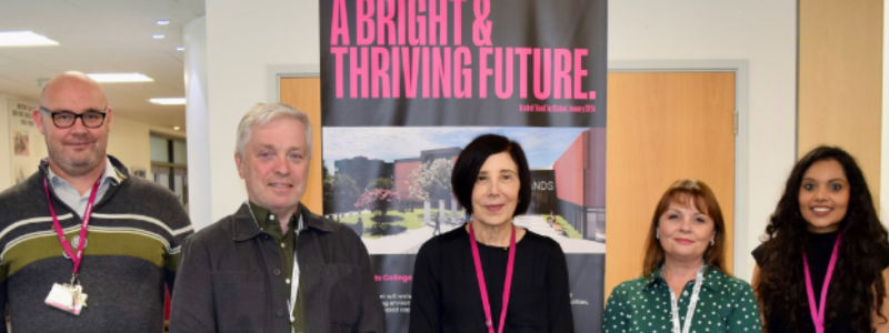 Five people stood in front of sign saying a bright and thriving future