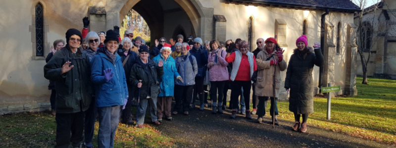 Group of people outside a church in warm clothing