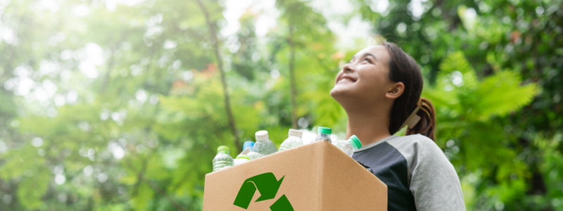 Woman holding a box of empty plastic bottles