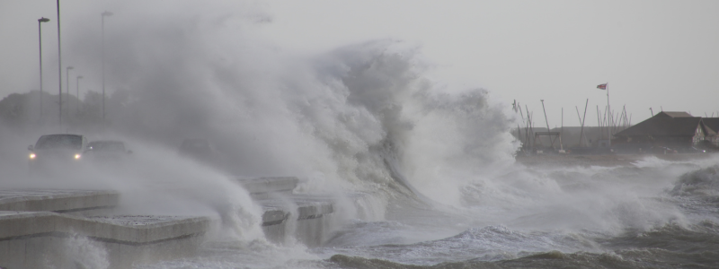 Waves crashing onto roads in a storm