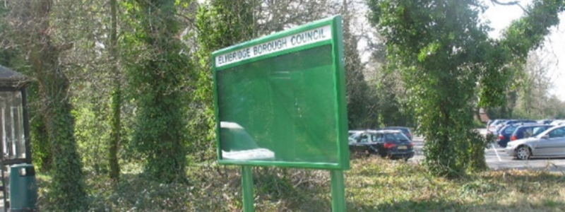 Elmbridge Borough Council noticeboard in front of a car park