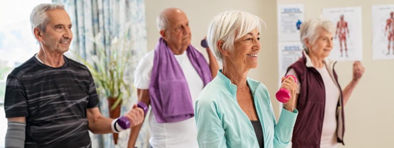 People exercising with dumbbells in a community centre