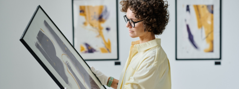 Person holding a piece of artwork in a frame