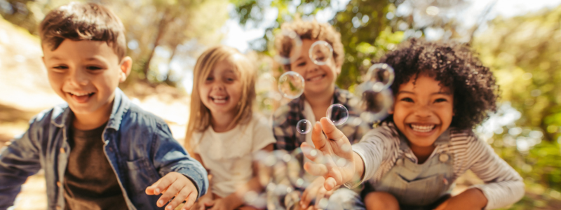 children playing smiling facing camera