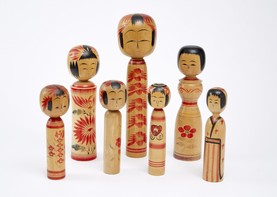Japanese kokeshi dolls made of wood and painted with faces and patterns