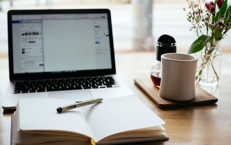 note book next to a laptop