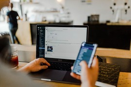 person using phone and computer