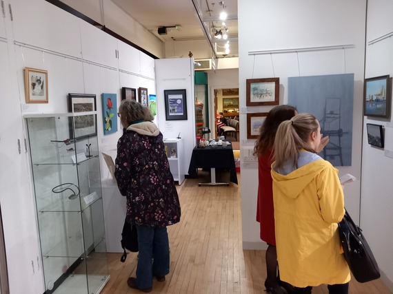 visitors looking into a glass case at an exhibition
