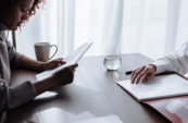 A photo of two people looking at documents