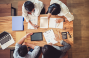 A photo of colleagues around a table having a discussion