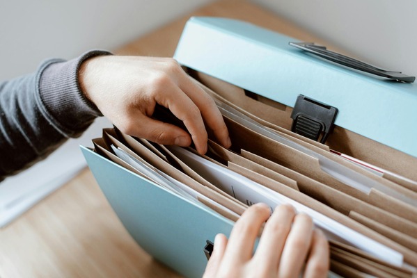 A photo of a person looking through a file