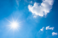 A photo of the bright sun in a clear blue sky