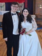 A photo of Daniel and Elizabeth smiling at their wedding