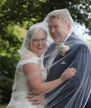 A photo of Connor and Katie Taylor smiling on their wedding day