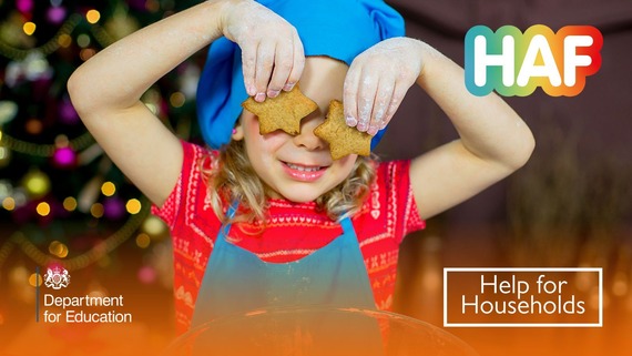 A child holding star-shaped biscuits in front of her eyes