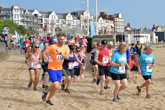 people running on a beach