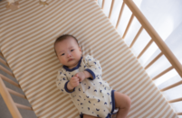 A photo of a baby in a cot