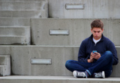 A photo of a teenager using his phone