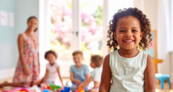 A photo of smiling children in a classroom